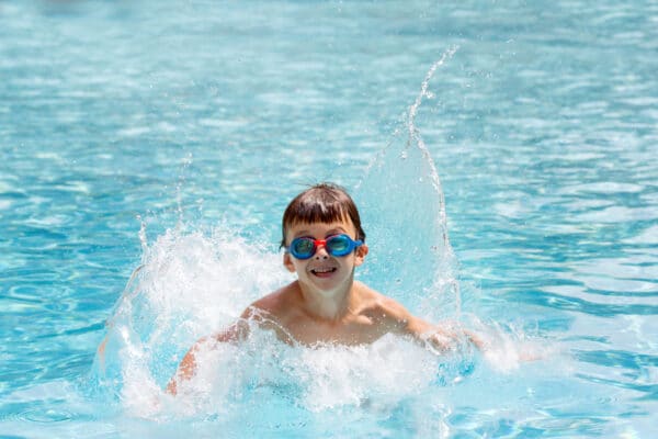 Kdis, jump in water pool on holiday, family vacation in summer resort
