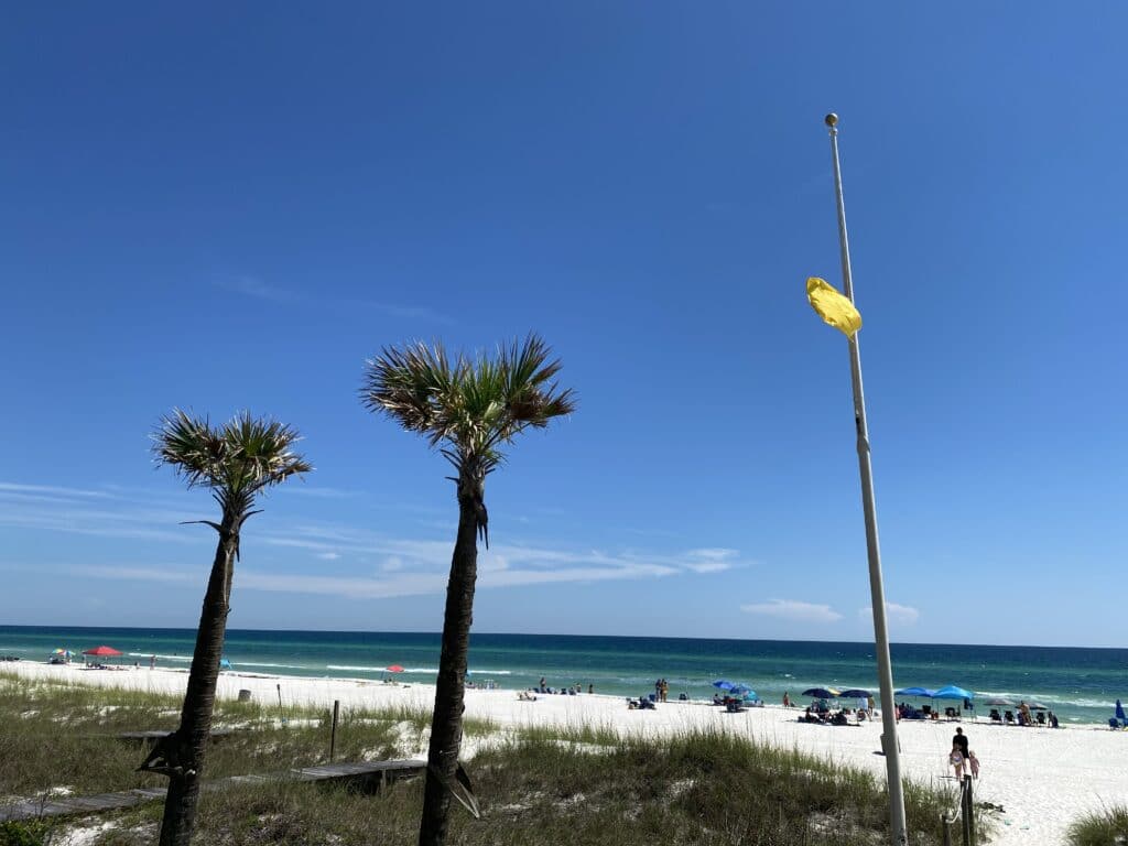 Yellow flag flying at beach access #93 on West End PCB