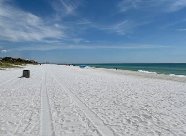 Sunny shoreline with white sand and emerald water in West End Panama City Beach, FL on October 28, 2026.
